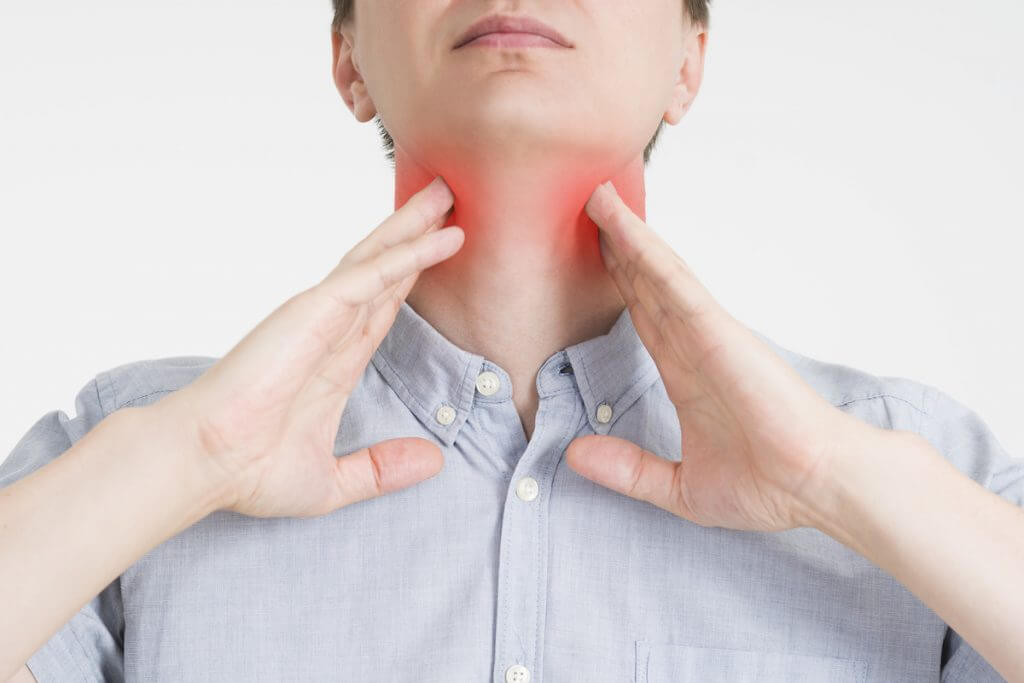 Sore throat, men with pain in neck, gray background